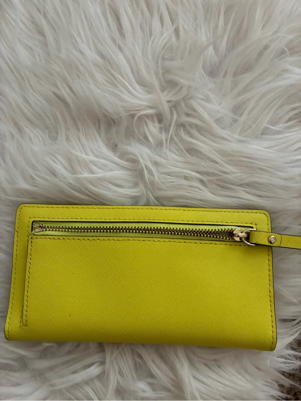 Lime green Kate Spade New York slim bifold wallet features multiple card slots